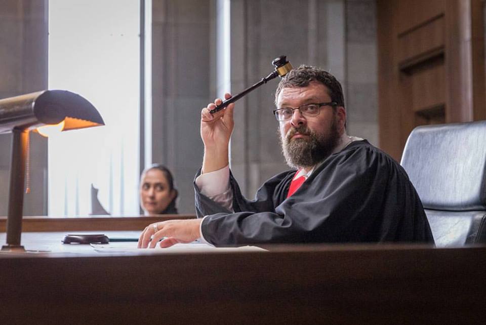 Behind the scenes photo of Christopher as a judge on the set of "The Witness Box"
